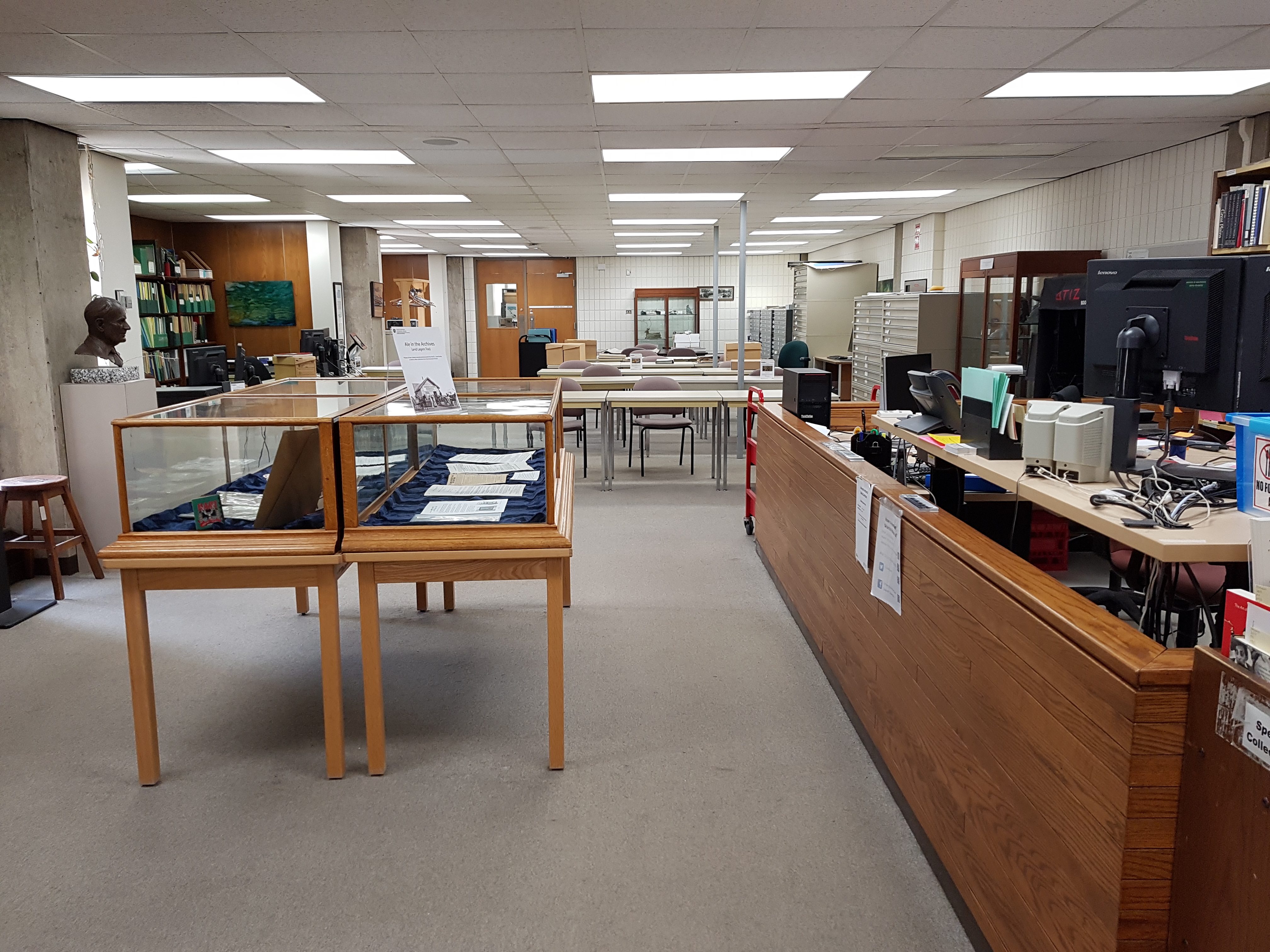 Photograph of display cabinets and tables in the UASC reading room.