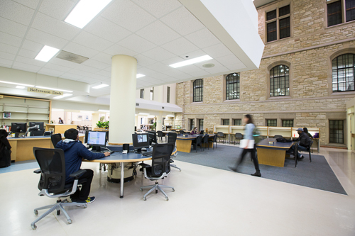Students at computers and desks inside the Science Library, ground floor. 